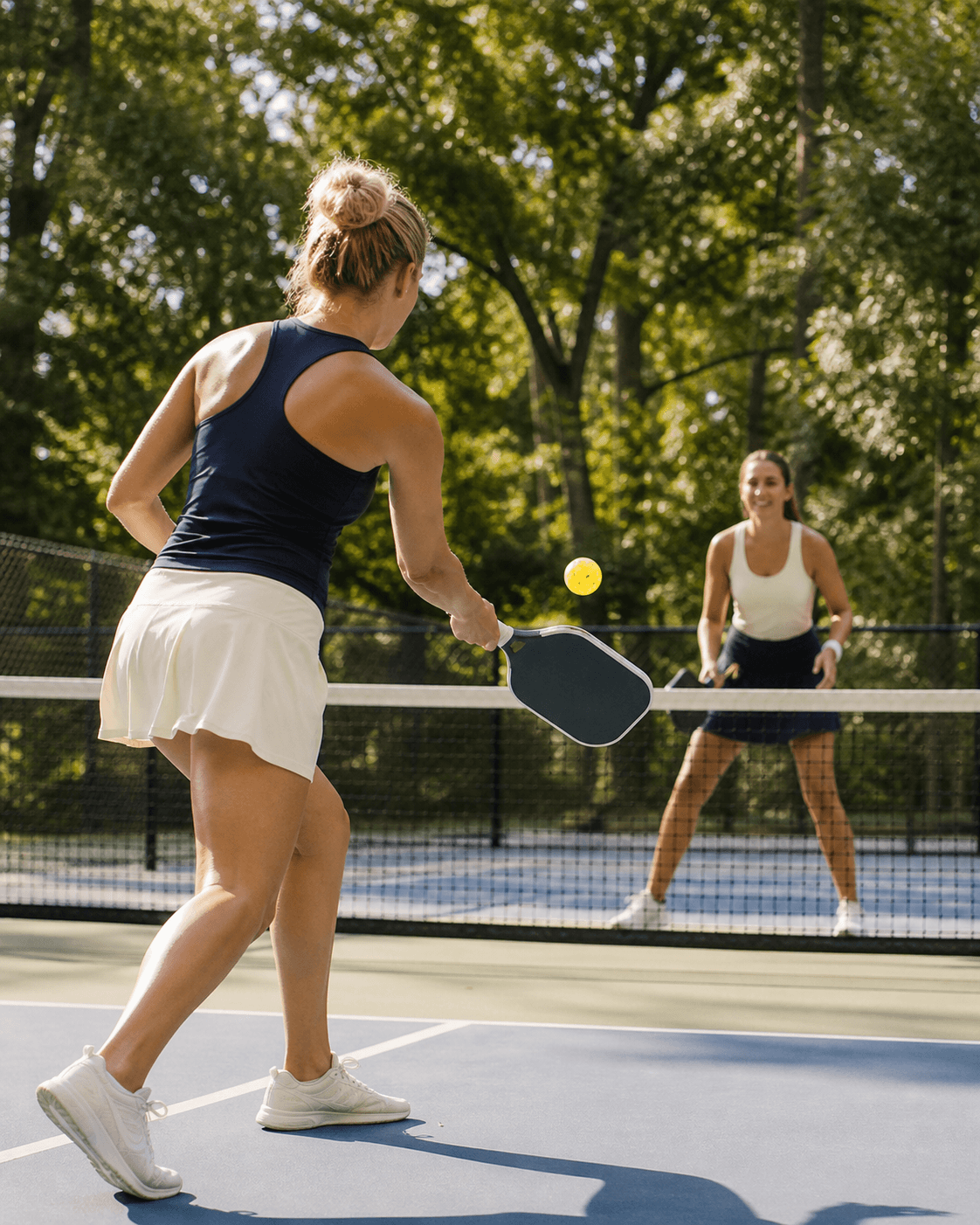 Two women playing pickleball